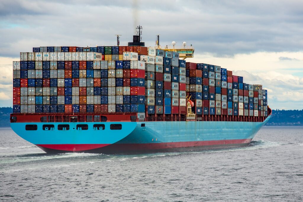 A fully loaded container ship sailing on the open sea