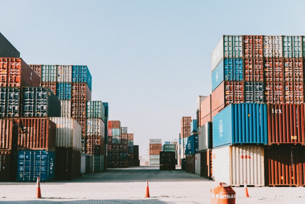 Stacks of colourful shipping containers at a container terminal